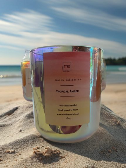 Hand-poured 16 oz Tropical Amber candle made with coconut apricot wax, featuring a warm golden tropical fragrance inspired by island fruits and smooth amber.
